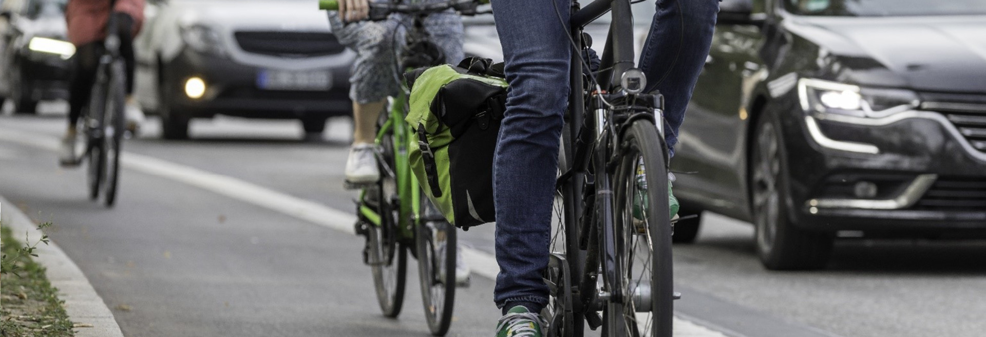 City street with bicyclists and cars.