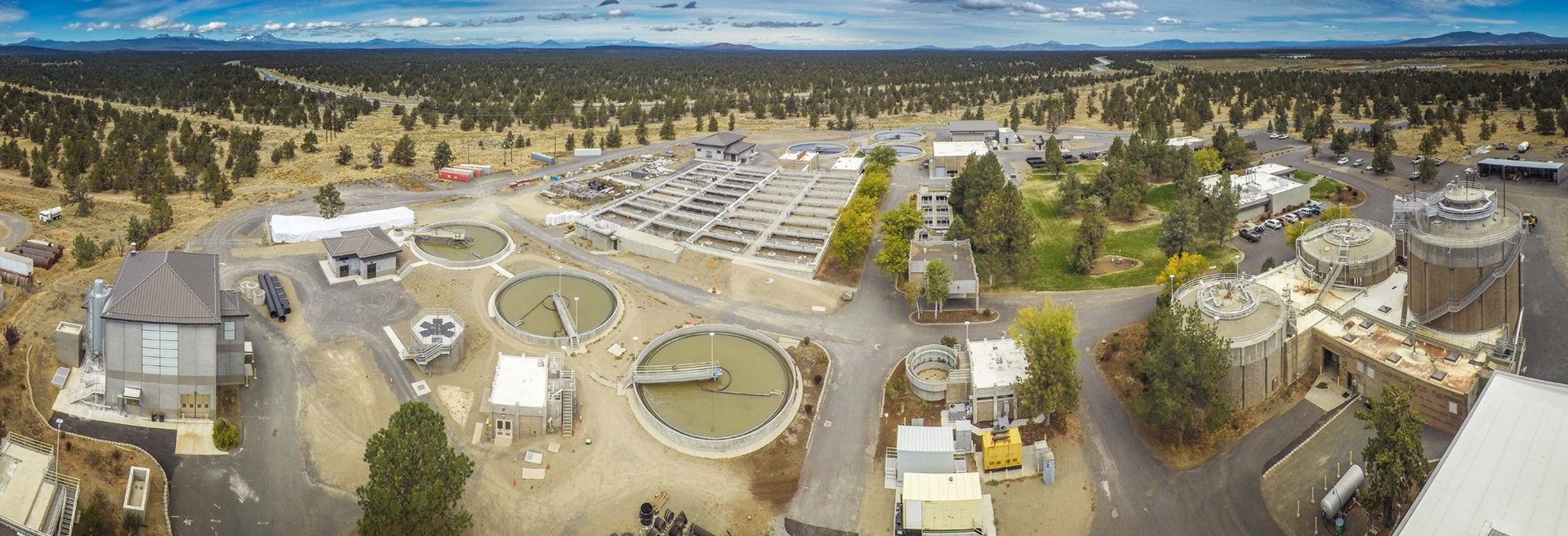 Drone shot of the Wastewater Collection System. Large tanks and facilities and pipes.